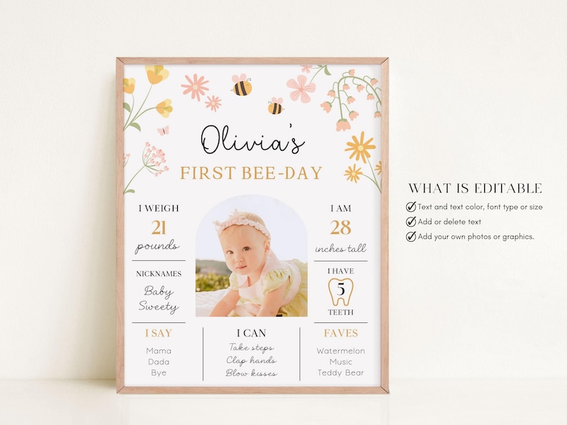 May include: A framed "First Bee-Day" sign with floral and bee illustrations. The sign includes a baby's photo, weight (21 pounds), height (28 inches), and other details. The text "Olivia's" is at the top.