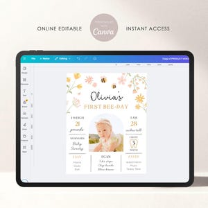 May include: A digital baby milestone sign displayed on a tablet. The sign features the text "Olivia's First Bee-Day" with floral and bee illustrations. It includes baby's weight (21 pounds) and height (28 inches).