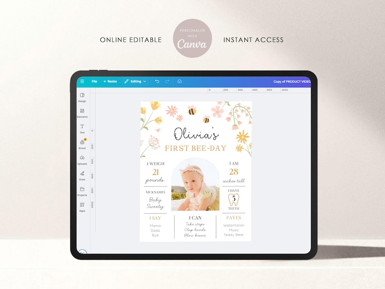 May include: A digital baby milestone sign displayed on a tablet. The sign features the text "Olivia's First Bee-Day" with floral and bee illustrations. It includes baby's weight (21 pounds) and height (28 inches).