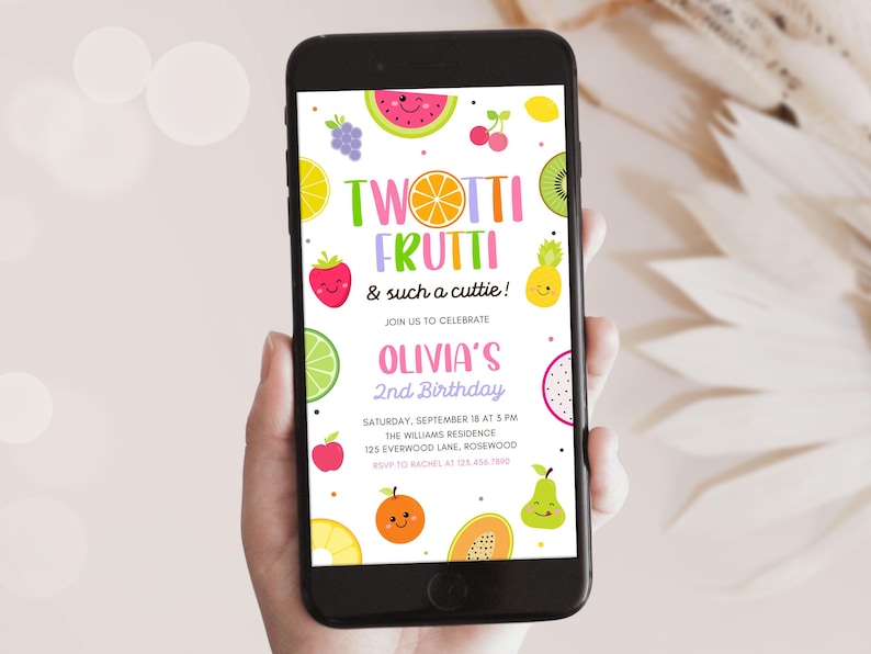 May include: A smartphone displays a colorful invitation for Olivia's 2nd birthday party. The design features cartoon fruits like watermelon, strawberries, and kiwi. Text reads "Twotti Frutti & such a cuttie!" and event details.