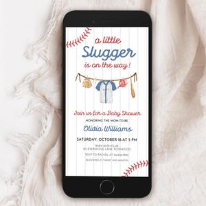 May include: A smartphone displays a baby shower invitation with a baseball theme. The text reads "a little Slugger is on the way!" with baseball-themed illustrations. The invitation includes the honoree's name, date, time, and location.