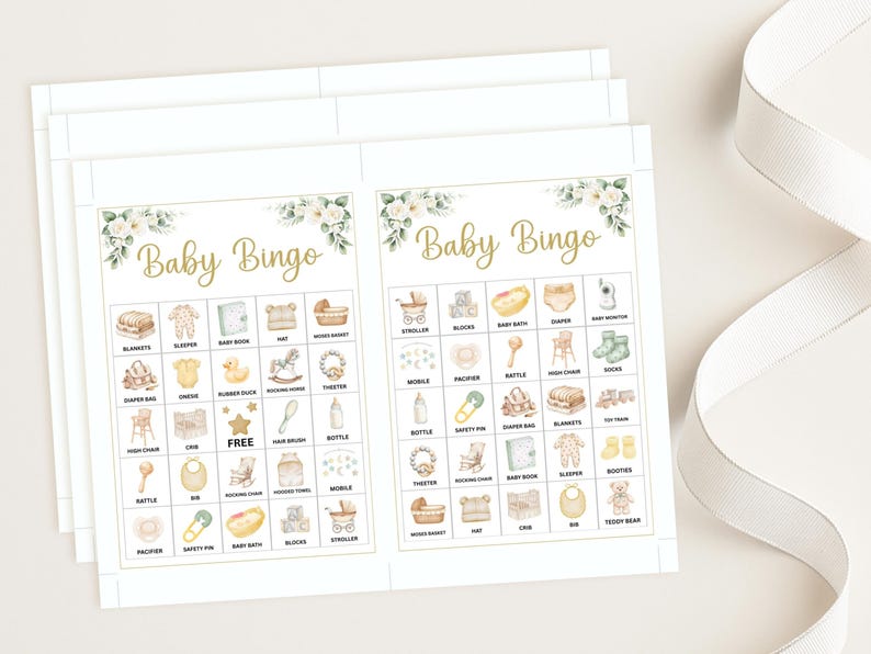 May include: Baby Bingo game cards with a floral design in the corners. The cards have a gold font that reads "Baby Bingo". The bingo cards have illustrations of baby-related items such as a stroller, blocks, and a baby bottle.