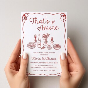 May include: A white bridal shower invitation with red text and illustrations. The text reads "That's Amore" and includes details about the event, including the date, time, location, and RSVP information.