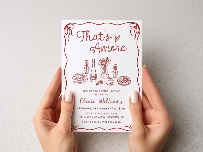 May include: A white bridal shower invitation with red text and illustrations. The text reads "That's Amore" and includes details about the event, including the date, time, location, and RSVP information.