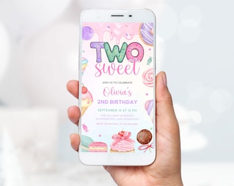 May include: A smartphone displays a colorful invitation for a second birthday party. The design features the words "Two Sweet" in a playful font, surrounded by illustrations of sweets like donuts, ice cream, and cupcakes. The invitation includes the name "Olivia's" and event details.
