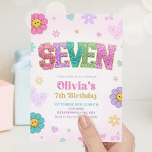 May include: A pink invitation card with the word "SEVEN" in glittery letters. The card is decorated with flowers, butterflies, and stars. The text reads "Olivia's 7th Birthday" and includes event details.