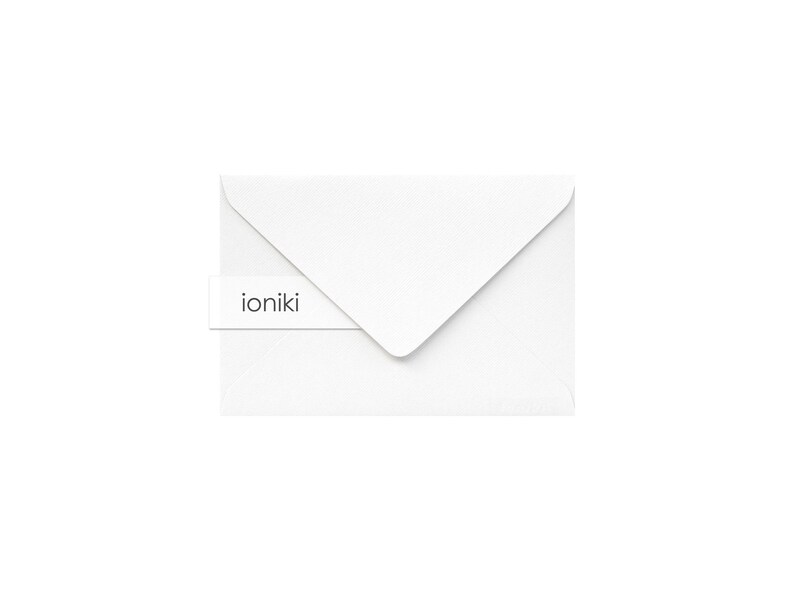 May include: White envelope with a small white label that says "ioniki" on it.
