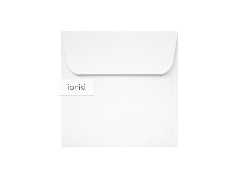 May include: White envelope with a small white label that says "ioniki" on it.