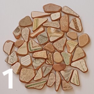 May include: A collection of small, irregular shaped ceramic tiles in shades of brown, beige, and green. The tiles have a rustic, handmade look and are perfect for adding a touch of natural beauty to any project.