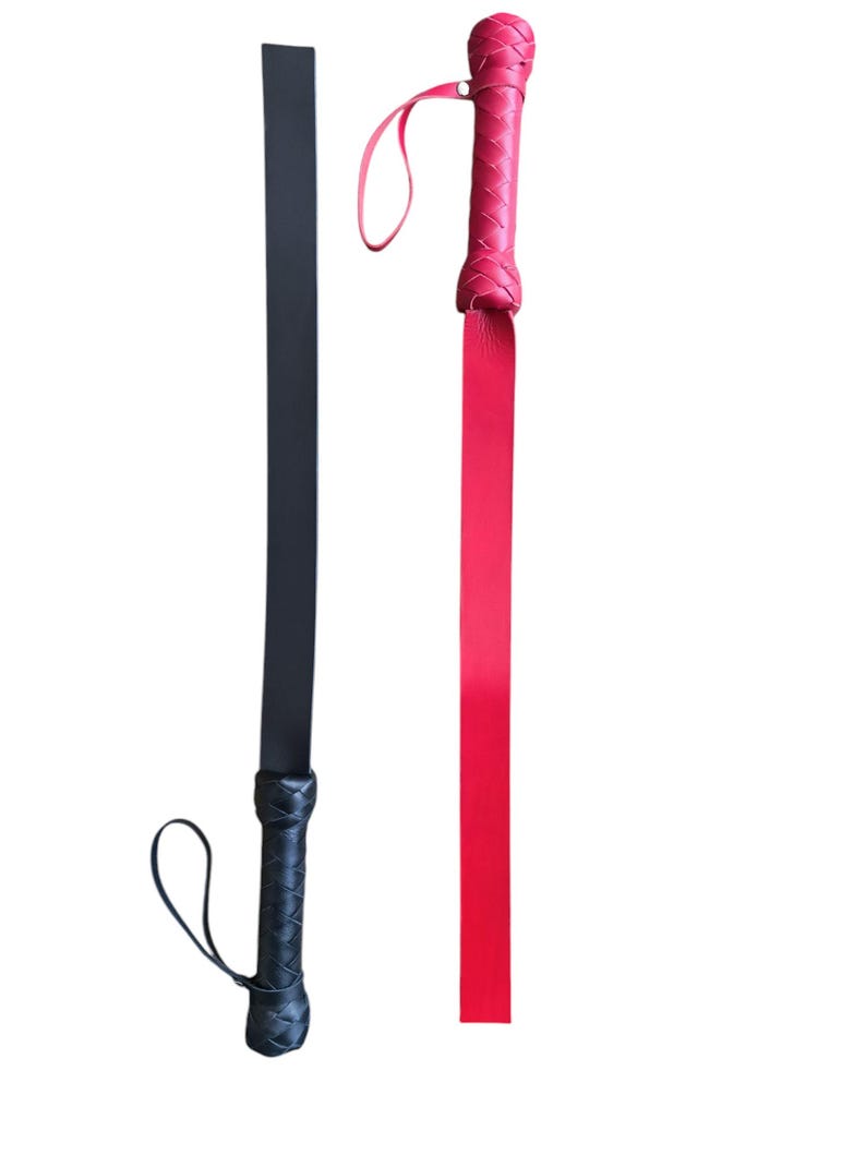 May include: Two leather whips, one black and one red, with braided handles and straps.