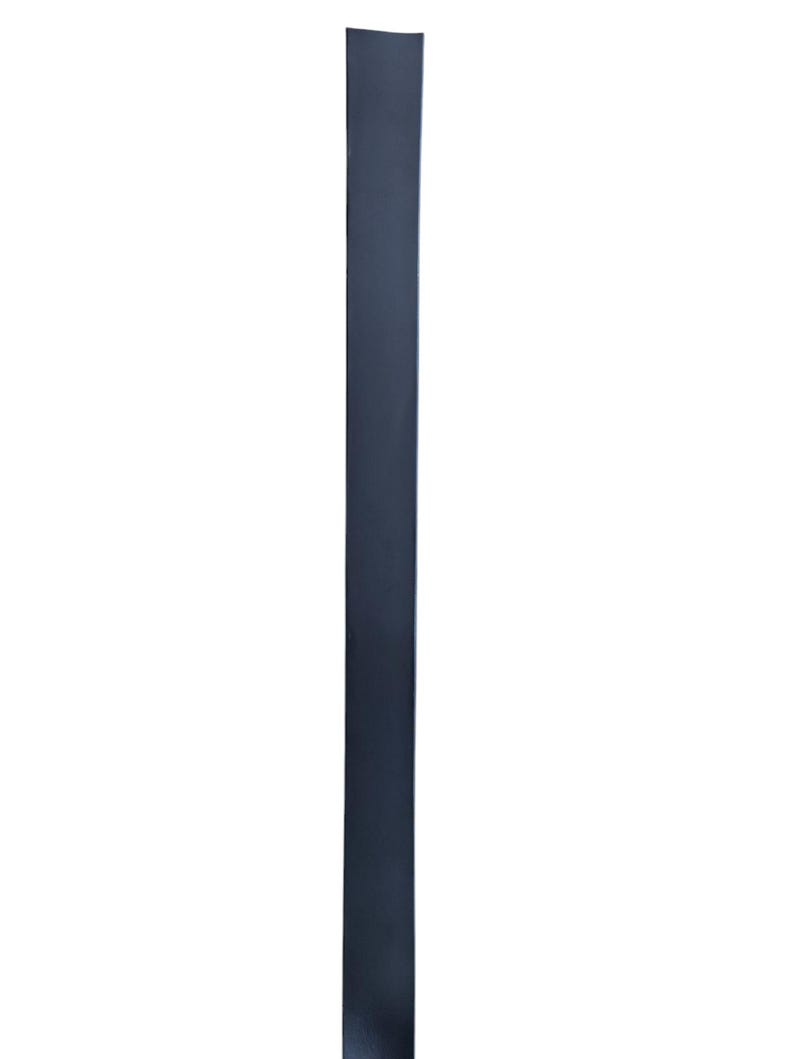 May include: A black heat shrink tubing, a type of electrical insulation used to protect wires and cables.