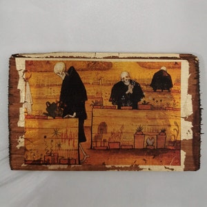 May include: A wooden plaque with a painting of three skeletons tending to a garden. The skeletons are wearing black robes and are surrounded by plants and flowers. The plaque has a rustic, aged look.