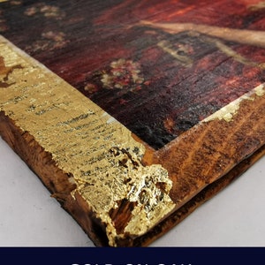 May include: A close-up of a wooden frame with gold leaf accents. The frame is made of oak wood and has a rustic look. The gold leaf is applied in a random pattern, creating a unique and eye-catching design.