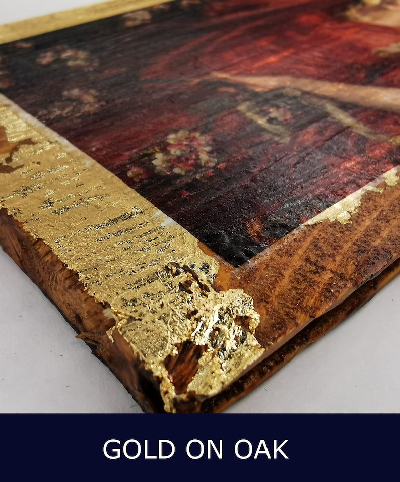May include: A close-up of a wooden frame with gold leaf accents. The frame is made of oak wood and has a rustic look. The gold leaf is applied in a random pattern, creating a unique and eye-catching design.