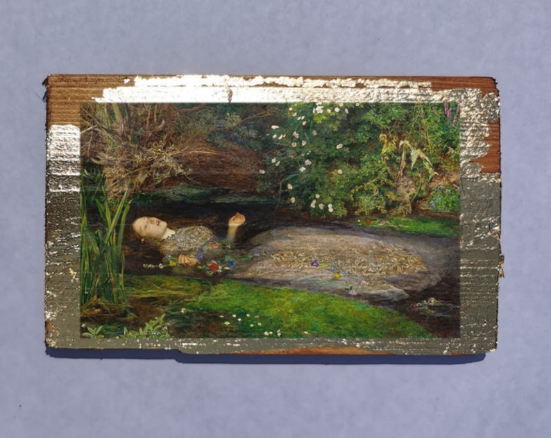 May include: A painting of a woman lying in a stream of water. The woman is wearing a white dress and has long, dark hair. The water is clear and the stream is surrounded by green plants and flowers.