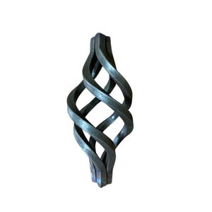 May include: A dark gray, wrought iron basket with a twisted, interwoven design. The metalwork features a series of curved bars that create an open, cage-like structure. The basket is designed to hold items and has a rustic, industrial aesthetic.