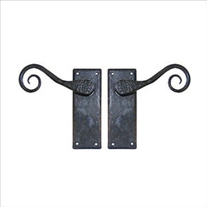 May include: A pair of black wrought iron door handles with a decorative scroll design. The handles are attached to rectangular plates.