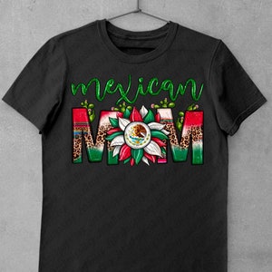 May include: Black t-shirt with the words "Mexican MOM" in a colorful design. The word "Mexican" is in green script, and "MOM" features a floral design with the Mexican flag and cactus accents.