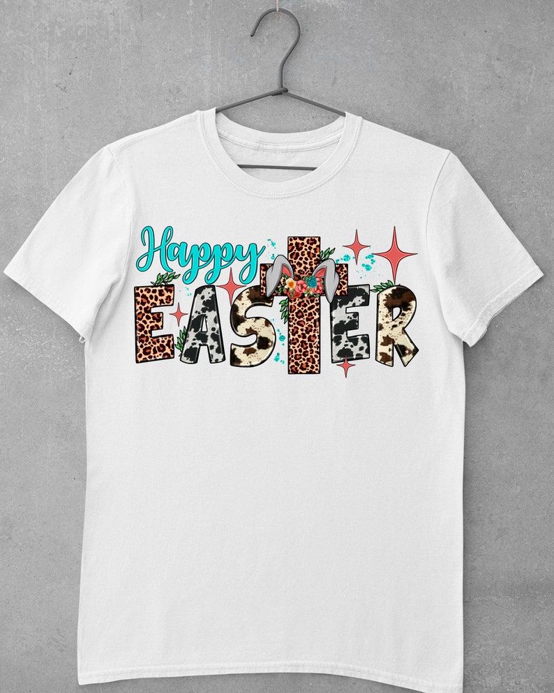 May include: White t-shirt with the text "Happy Easter" in colourful letters with animal print patterns and a cross behind the word "Easter".
