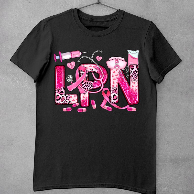 May include: Black t-shirt with a pink and white design that says "LPN" with a pink ribbon, stethoscope, pills, and other medical symbols.