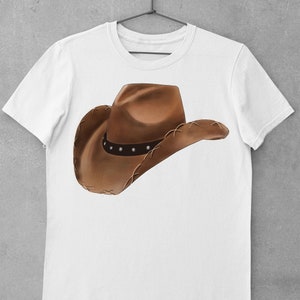 May include: White t-shirt with a brown cowboy hat graphic.