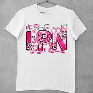May include: White t-shirt with a pink glitter design that says "LPN" with pink medical symbols and a pink ribbon.