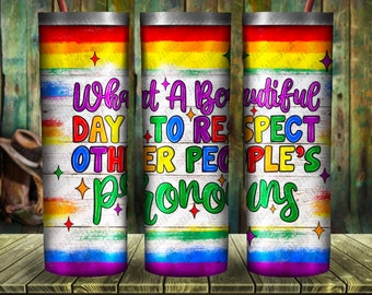 May include: Three stainless steel tumblers with a rainbow design and the text "What a Beautiful Day to Respect Other People's Pronouns".