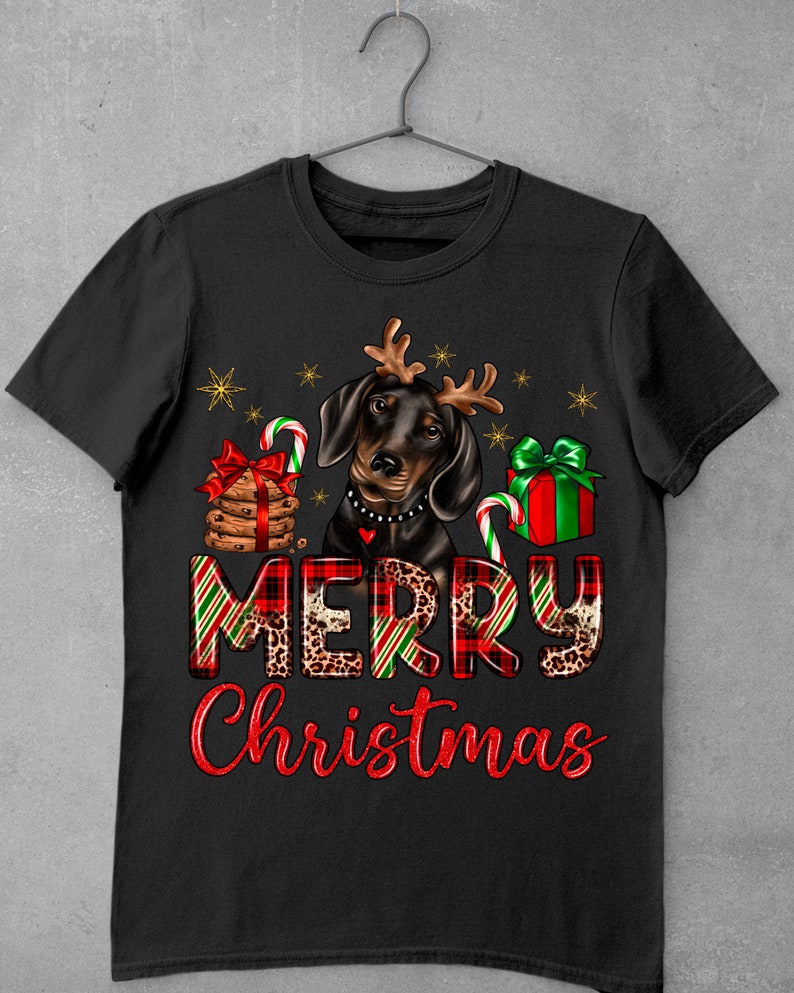May include: Black and brown dachshund wearing reindeer antlers with a red and green plaid "Merry Christmas" text and Christmas-themed decorations.