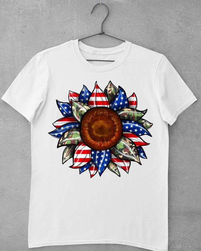 May include: White t-shirt with a red, white, and blue sunflower design. The sunflower petals are patterned with the American flag and camouflage.