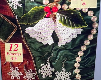 May include: A close-up of two pairs of crocheted snowflake earrings and a pair of crocheted bell earrings. The earrings are displayed on a green velvet background with a pearl necklace and a sprig of holly.