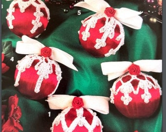 May include: Five red and white Christmas ornaments with white lace trim and white bows. The ornaments are on a green background.