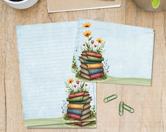 May include: Stationery set featuring lined paper and notecards. The notecards display a stack of colorful books with flowers and greenery. The design includes orange and red flowers, and the books are in shades of red, green, yellow, and blue.