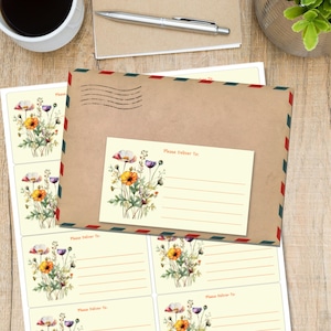 Può includere: Un'etichetta di spedizione rettangolare con un'illustrazione ad acquerello di fiori di campo arancioni, viola e verdi. L'etichetta include il testo "Please Deliver To:" sopra quattro linee orizzontali per scrivere un indirizzo su un foglio.