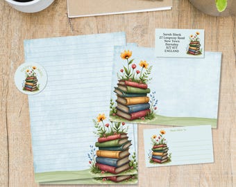 May include: Stationery set featuring a watercolor illustration of a stack of books with flowers. Includes lined paper, a sticker, a notecard, and an address card. The stationery has a light blue background and a green border.