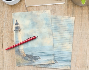 May include: Two notepads with a lighthouse scene and lined paper, alongside a red pen, a silver pen, and a cup of coffee on a wooden surface. The lighthouse image features a white tower, blue sky, and ocean waves.