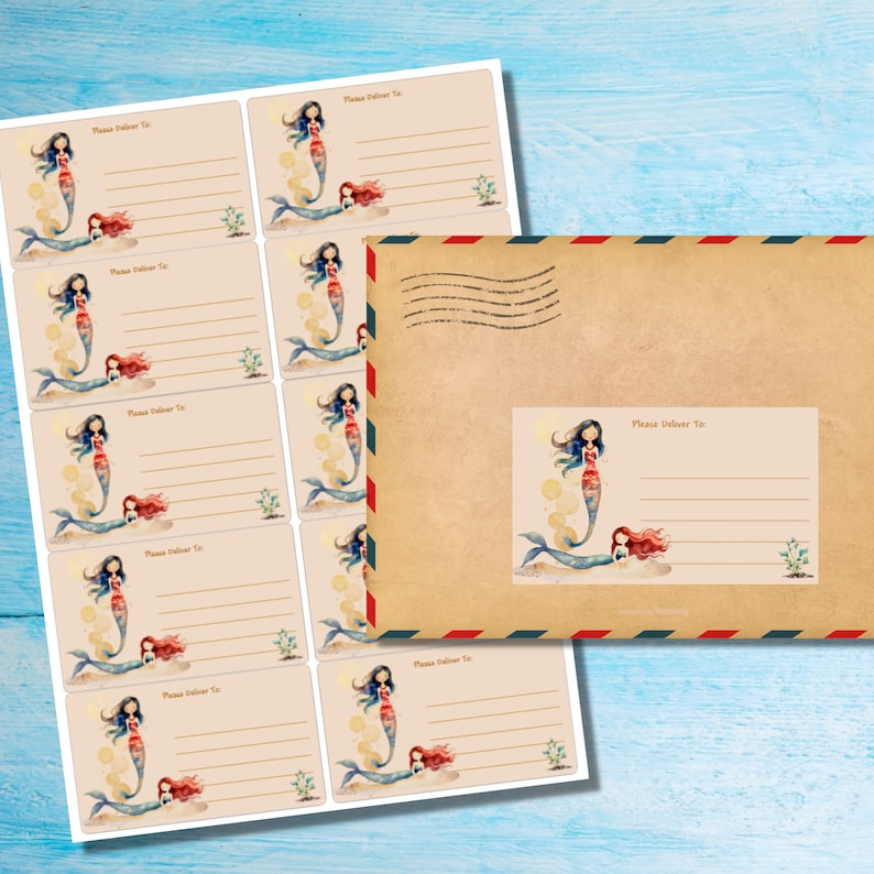 May include: Sheets of mermaid-themed address labels and a matching envelope. The labels feature illustrations of mermaids with blue and red hair, and the text "Please Deliver To:" is printed on each label.