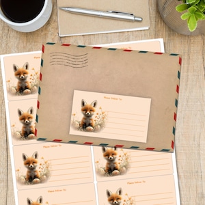 May include: A stationery set with a fox theme. The set includes a large brown envelope with red, white, and blue trim, an address card, and sticker labels. Each item features a fox illustration and the words "Please Deliver To".