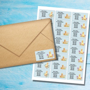 May include: A sheet of address labels with a light blue background and a cute cartoon duckling design. The labels are printed with the text "Sarah Black, 27 Longty Road, New Town, Barnsley, 877 8TT, ENGLAND".