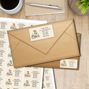 May include: Kraft brown envelopes with address labels featuring a whimsical illustration of a duck in a hat. The labels display the name "Sarah Black" and address details. A sheet of matching labels is visible.