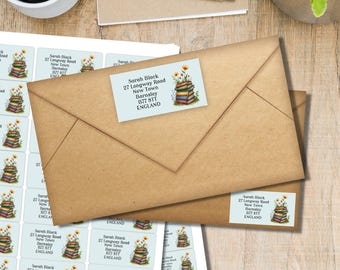 May include: Two brown envelopes with address labels featuring a stack of books and flowers. The labels include the name "Sarah Black" and address details. A sheet of matching labels is visible.