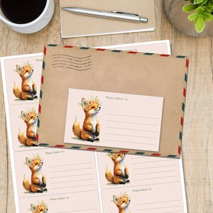 May include: A stationery set with a watercolour illustration of a fox wearing a floral crown. The set includes address labels and an envelope with a matching design. The envelope has a red, white, and blue border and the words "Please Deliver To:" printed on the address label.