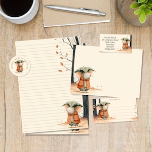 May include: Stationery set featuring a mouse wearing an orange coat and holding a green leaf umbrella. Includes lined paper, envelopes, and labels with the text Sarah Black, 27 Longway Road, New Town, Barnsley, B77 877, ENGLAND and Sending Smiles.