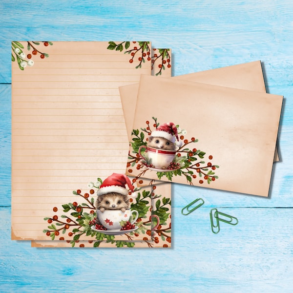Puede incluir: Un conjunto de tres hojas de papel de cartas de estilo vintage con un área de escritura rayada y un diseño navideño festivo con erizos que llevan gorros de Papá Noel y sentados en tazas de té. El diseño incluye bayas rojas y hojas verdes.