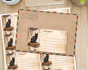 May include: A brown paper envelope with red and blue airmail borders sits atop a sheet of printed mailing labels. Each label features a vintage-style illustration of a black cat sitting on a stack of books, the text Oct 31st 1898, and Please Deliver To.