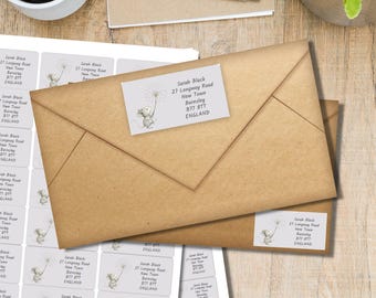 May include: Kraft paper envelopes with address labels featuring a whimsical illustration of a mouse blowing a dandelion. The labels include the text "Sarah Black, 27 Longway Road, New Town, Barnsley, B77 8TT, ENGLAND."