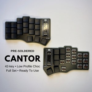 May include: A pre-soldered 42-key mechanical keyboard with low profile chocolate switches. The keyboard is green and black and has a unique curved design. The text "PRE-SOLDERED CANTOR 42-key Low Profile Choc Full Set Ready To Use" is printed on the keyboard.