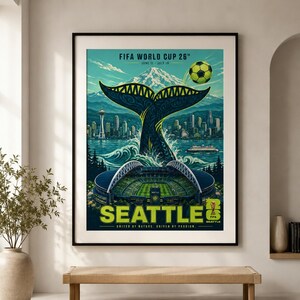 May include: A framed poster for the FIFA World Cup 26 in Seattle, featuring a whale tail rising from the water, the Seattle skyline with the Space Needle, a soccer stadium, a soccer ball, and the text FIFA WORLD CUP 26, SEATTLE, UNITED BY NATURE.