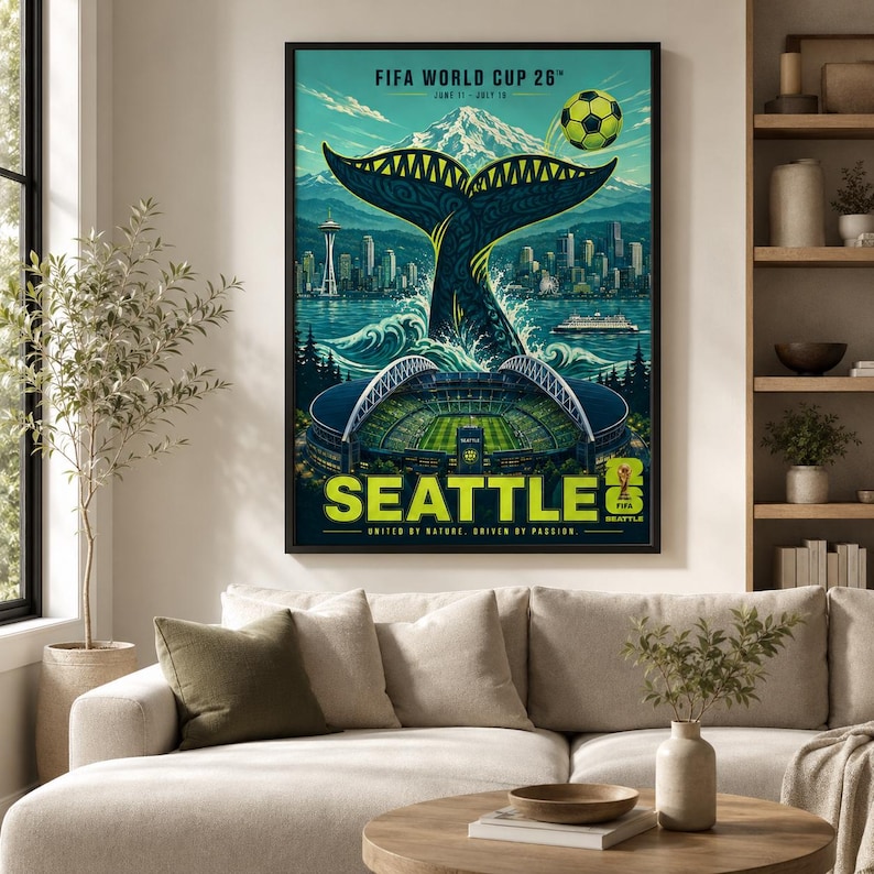 May include: A framed poster for the FIFA World Cup 26 in Seattle, featuring a whale tail rising from water, the Seattle skyline with the Space Needle, a soccer stadium, a soccer ball, and Mount Rainier, with text reading FIFA WORLD CUP 26.