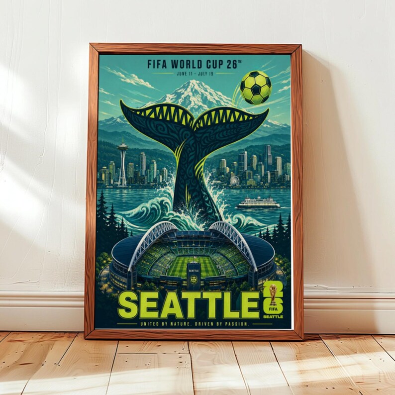 May include: A framed poster for the FIFA World Cup 26 in Seattle featuring a large whale tail rising from the water, the Seattle skyline, a soccer stadium, a soccer ball, and Mount Rainier. The text reads FIFA WORLD CUP 26, SEATTLE, and UNITED BY NATURE. DRIVEN BY PASSION.