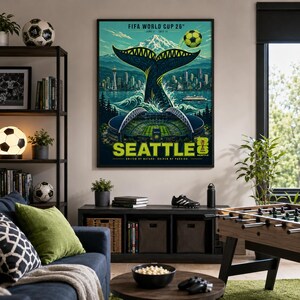 May include: A rectangular wall poster featuring a stylized graphic of a whale tail rising from water in front of the Seattle skyline, Mount Rainier, and a stadium. The text reads FIFA WORLD CUP 26, SEATTLE, and UNITED BY NATURE. DRIVEN BY PASSION.